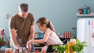 Vater und Kind beim Zubereiten von Dampfgarer Rezepte